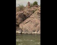 Lady does cartwheel off rock into river 
