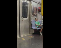 Kid in train with balloon looks at spiderman