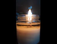 Bubble rises on surface of the candle