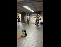 Guy blue shirt handstand dance train station