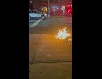 Trash and trash can on fire outside