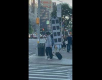 Two guy carry giant house doll the back and luggage bag 