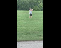 Two woman pink shirt play frisbee park