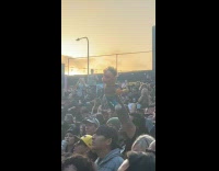 Fan Holds Up Ernie Puppet on Concert