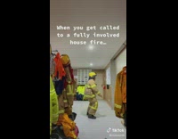 Firefighter puts on uniform and runs out through curtain 