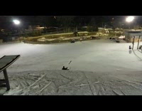 Skier jumps ramp falls on back