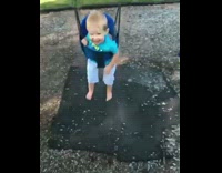 One toddler collides into another on the toddler swing