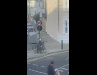 Woman green sweater frolic on street bike