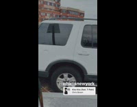 Three white cars parked bumper to bumper 