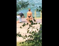 Woman back black swimsuit sea ladder trees