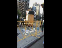 Giant inflatable Timbs boot shoe next to outdoor tent 