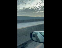 Man white sweater rides bike inside expressway