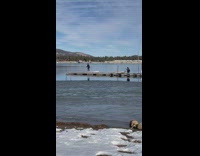 Man black winter coat dance boat dock