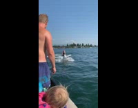 Guy red white jet ski catches snack 