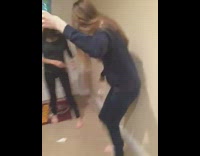 girl slides down stair rails hits wall