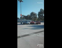 Three girls jump in vintage mustang cars 