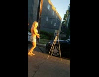 Brown bear with two people dance street