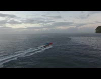 Aerial Drone Video follows the boat on the ocean at sundown
