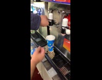 Man putting slurpee into cup and bursts
