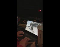 Collab JerrySlams - Guy plays ski game on laptop during movie in the theaters