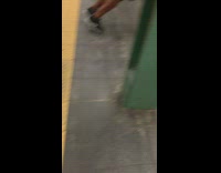 Man does push ups off a handrail in Times square subway station