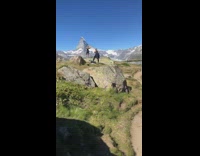 Woman black outfit hands sideways mountain pictorial