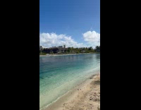 Woman upside down on beach zipline