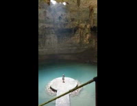 girl alone bottom of cave looks up