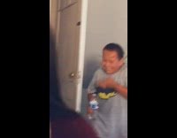 Grey shirt boy ducks hits face green ball