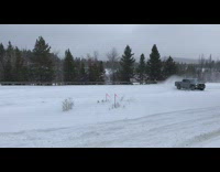 Person does donuts in snow field using rental truck