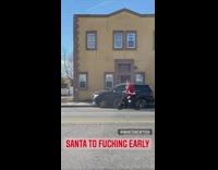 Santa rides bike on sunny day 