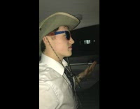 Guy hat glasses ride car listen music