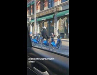 Guy rides backwards on parked citibike 