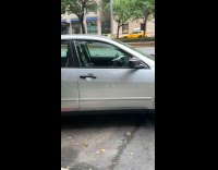 Collab WINY - Gray car on street lifted by hydraulic jack