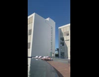 Woman white dress walk beside pool building