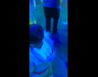 Little boy runs into mirror maze glowing rainbow colors