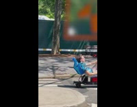 Guy sits on chair with electric skateboard 
