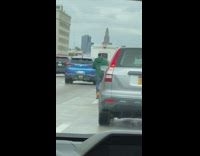 Guy Runs Down Freeway Next to Traffic 