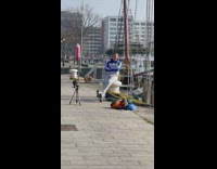 Man blue jacket Adidas sit boat dock