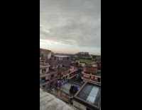 Full rainbow arch and sunset apartment rooftop