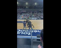 Globetrotter doing stanky leg dance with two kids on sideline
