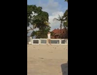 Girl white shirt walk pose beach barricade