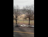 Car on street with stolen wheels snow