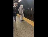 Robot waits for train inside subway station