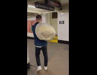 Guy carries big bag of popcorn 