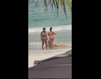 Woman in a thin bikini lie down on the beach shore Part 1