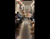 Woman red shirt brings pile of target trash bags on metro train