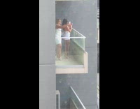 Two women in white dress selfie at the balcony