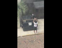 Woman in skull makeup rap inside garbage bin