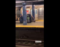 Rat costume guy climbs subway station bench 
